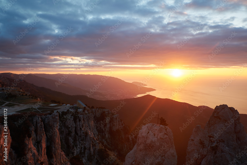 Beautiful sunrise in the mountains. Top of Ai Petri mountain sunset view. Crimea, Russia. vertical
