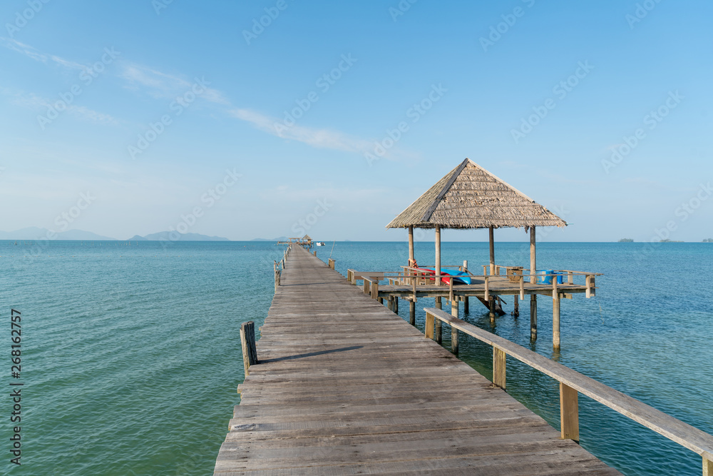 Wooden pier with boat in Phuket, Thailand. Summer, Travel, Vacation and Holiday concept. Wooden pier with boat in Phuket, Thailand. Summer, Travel, Vacation and Holiday concept.