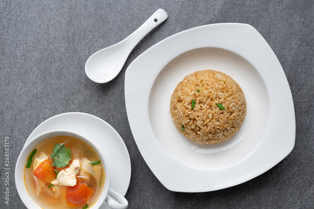 Garlic fried rice and hot soup chicken healthy at morning on concrete table. Garlic fried rice and hot soup chicken healthy at morning on concrete table.