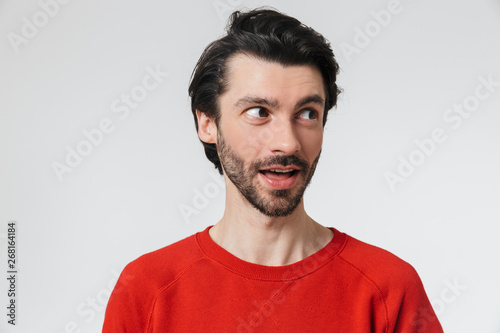 Handsome young happy man posing isolated over white wall background.