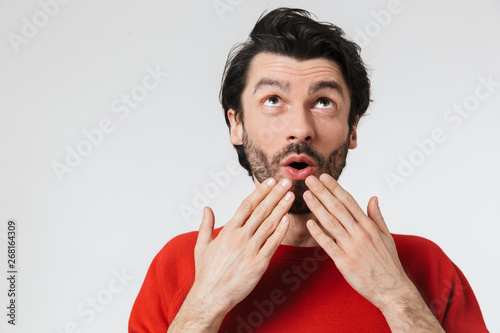 Man posing isolated over white wall background.