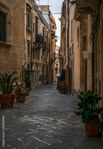 Typical italian street with plants in pots without people in the Ortigia island in Siracusa, Sicily, south Italy