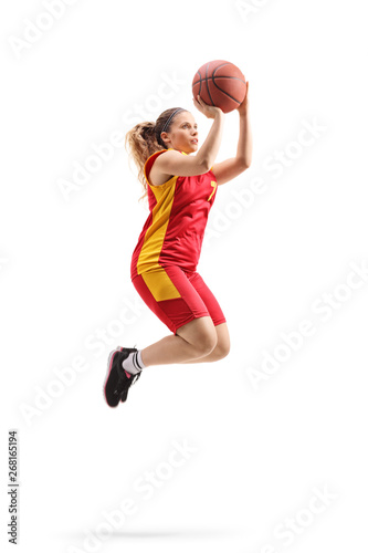 Female basketball player rjumping and shooting a ball