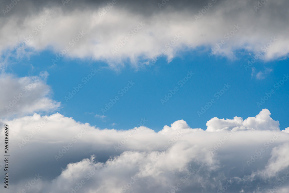 Storm clouds forming space for blue sky at springtime, copy space. Storm clouds forming space for blue sky at springtime, copy space.