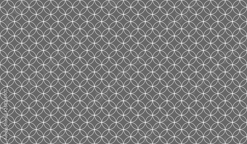 Abstract seamless pattern of overlapping thin white circles against a grey background, symmetrical design inspiration forming a pleasing, optical pattern used as a background or decorative purposes