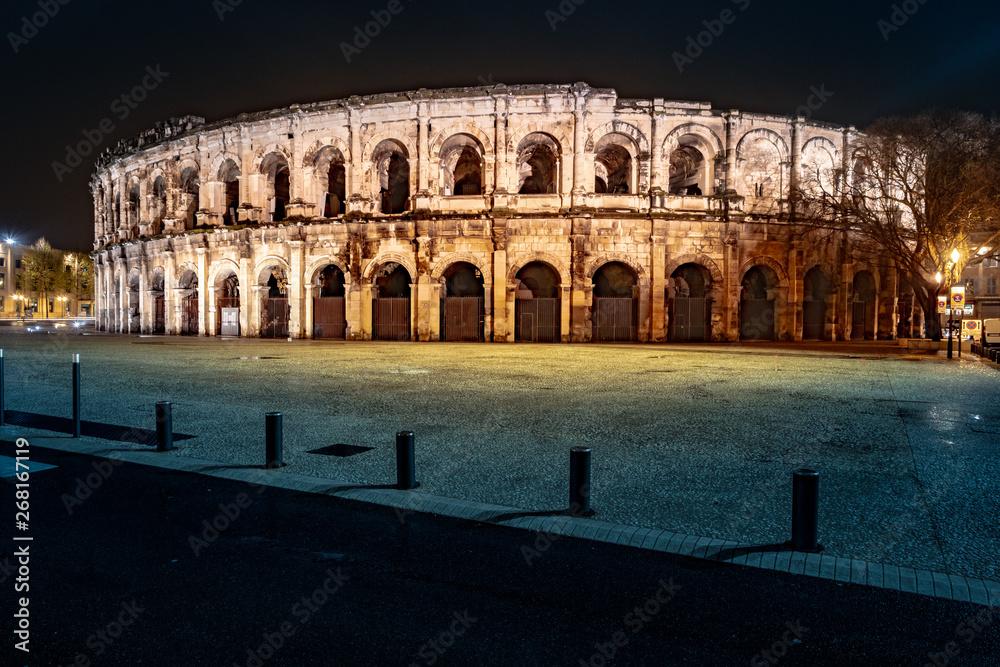 Panorama of illuminated Roman amphitheater in French city of Nimes