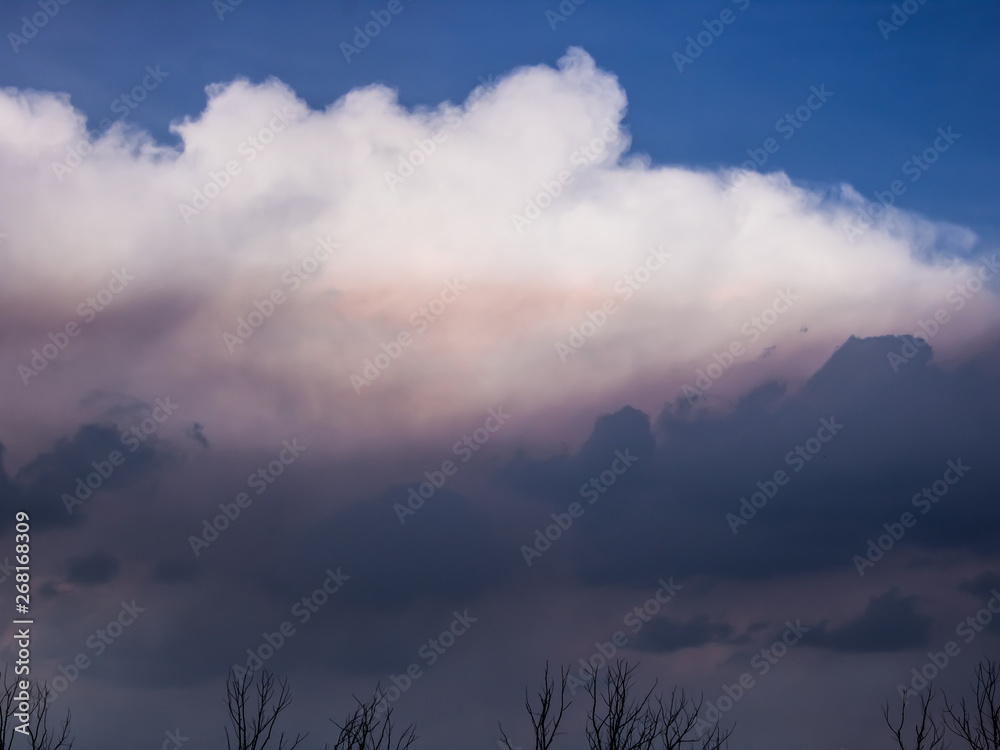 Clouds of thunder on the blue sky, backlit by the sun. Clouds of thunder on the blue sky, backlit by the sun.