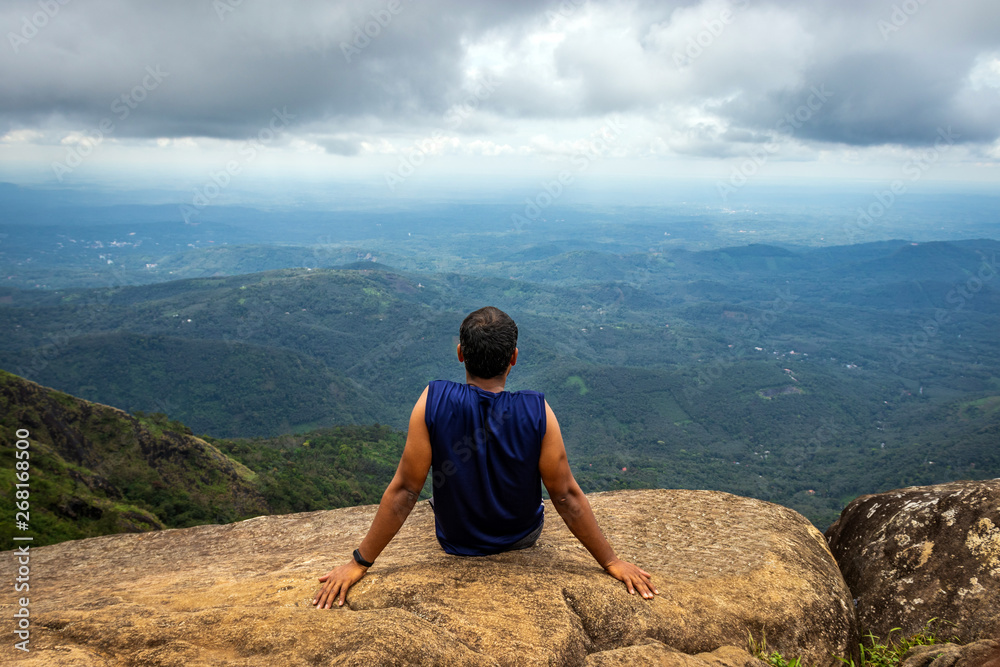 Man Isolated sitting on hilltop felling the nature