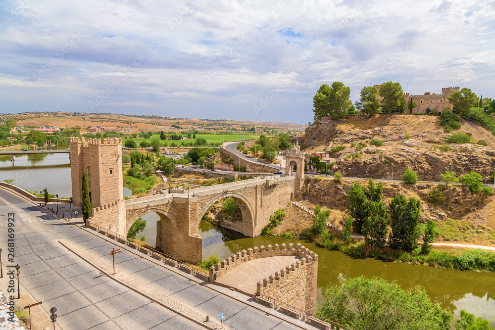 Toledo, Spain. Alcantara bridge over the Tajo river and San Servando castle