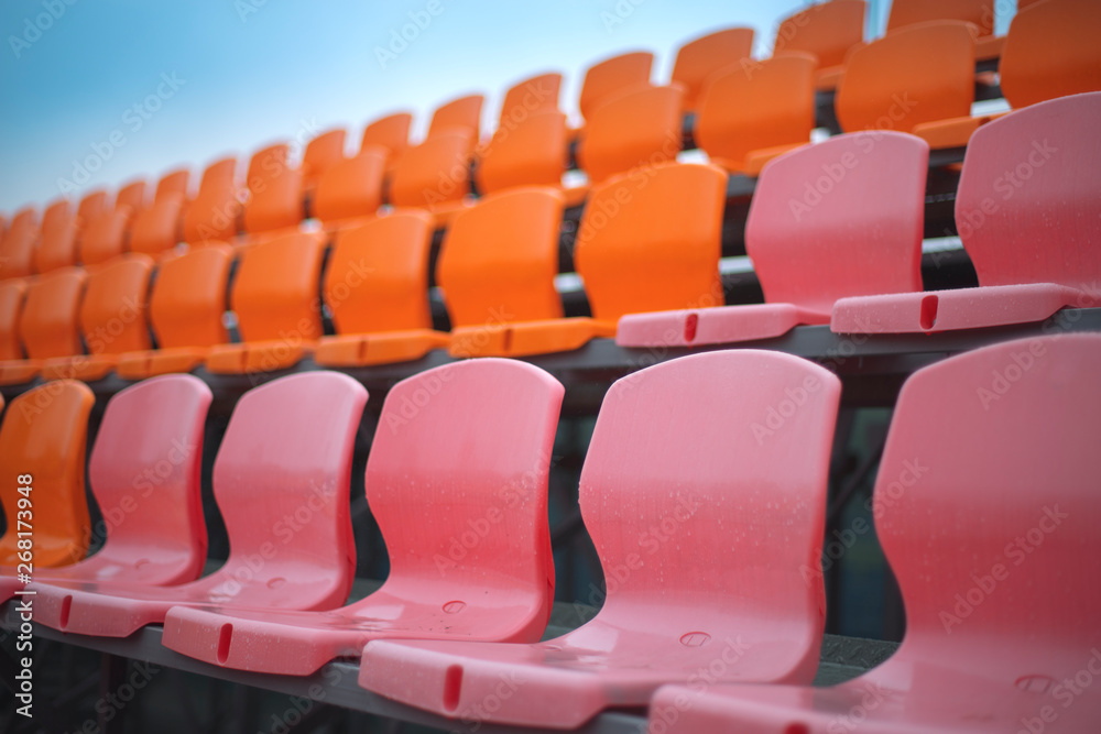 Fototapeta premium Empty colored chairs at the stadium