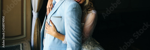 Bride and groom hugging. Wedding couple in love. Luxury dress.