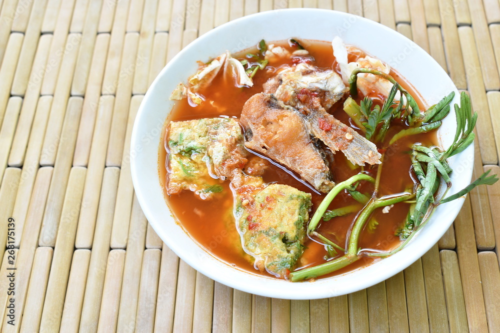 fried fish and egg stuffed climbing wattle in spicy sour soup on bowl fried fish and egg stuffed climbing wattle in spicy sour soup on bowl