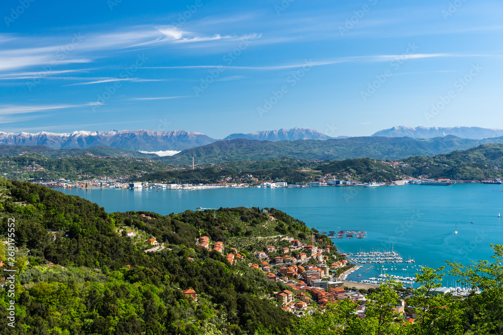 Striking view over the La Spezia Gulf and the Gulf of Poets (Golfo dei Poeti),on the Liguria's coast, Italy, with the silhouettes of the snow covered Italian Alps in the background