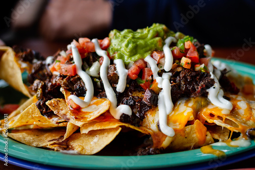Tableau sur toile Beef and cheese corn nachos served on a big plate ready to eat