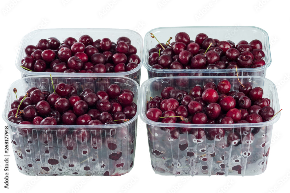 Harvest red sweet cherries in transparent plastic containers isolated on white background. Harvest red sweet cherries in transparent plastic containers isolated on white background.