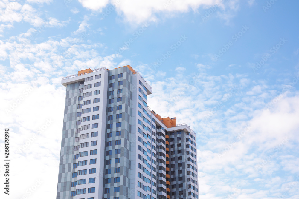 Building with tinted windows against cloudy sky. Modern architectural design Building with tinted windows against cloudy sky. Modern architectural design