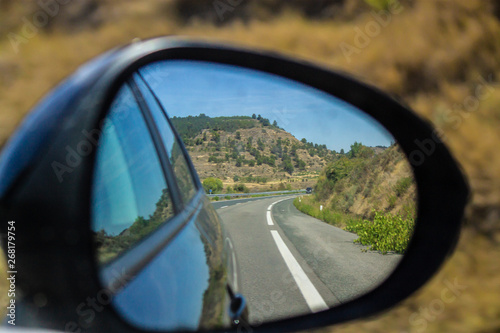 vision reflected in the rearview mirror of a car