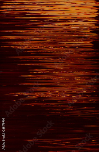Abstract art texture background. Moon light reflection on water surface design. Red shades paint with ripple effect.