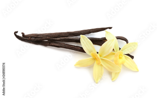 Aromatic vanilla sticks and flowers on white background
