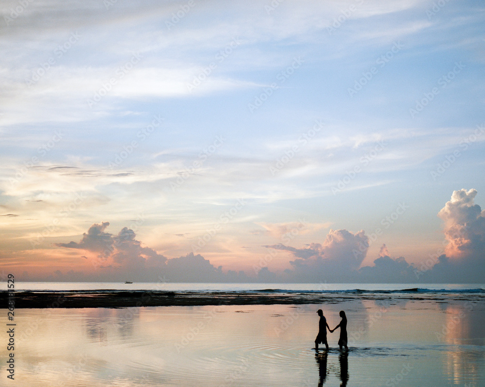 People in evening walking in ocean People in evening walking in ocean