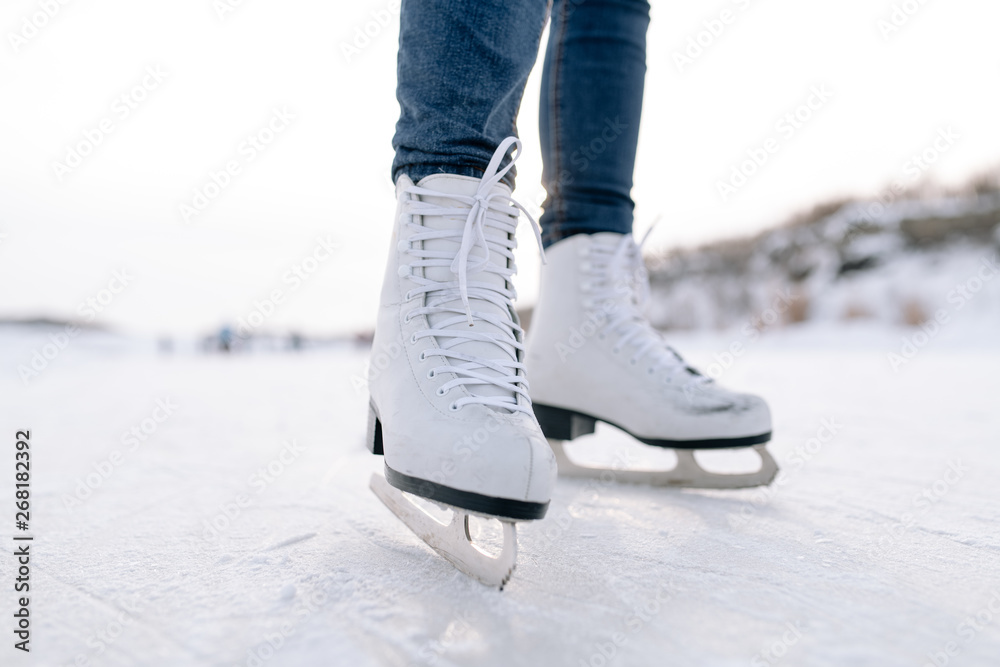 Crop woman skating on rink