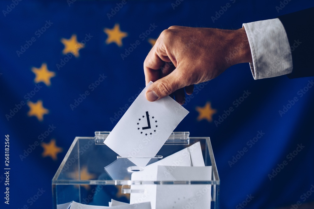 Man throwing his vote into the ballot box.