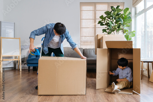 Father packing while kids playing at home