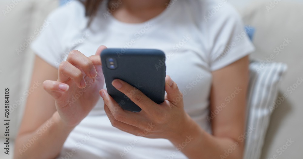 Close up of woman use of mobile phone at home Close up of woman use of mobile phone at home