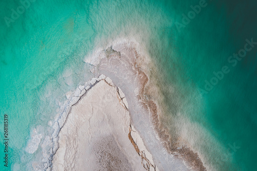 Aerial shot of salt formation penetrating the dead sea. Israel photo