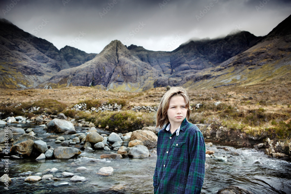 Portrait of a young boy near a mountain range Portrait of a young boy near a mountain range