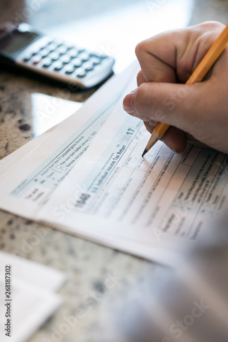 Taxes: Woman Filling Out 1040 Tax Form photo