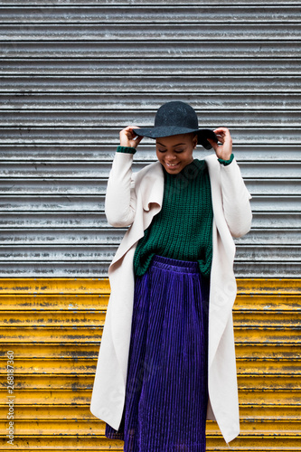 Portrait of a Stylish woman against iron wall photo