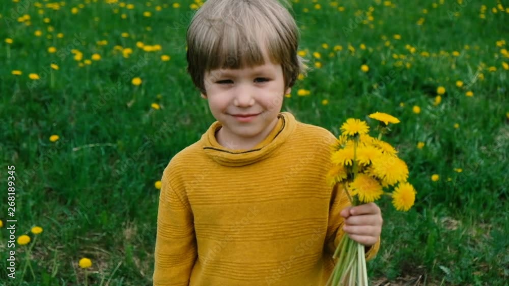 Cute little boy with dandelions, summer outdoors Cute little boy with dandelions, summer outdoors