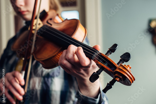 Teen girl practicing her violin