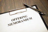 Offering memorandum document with pen on desk