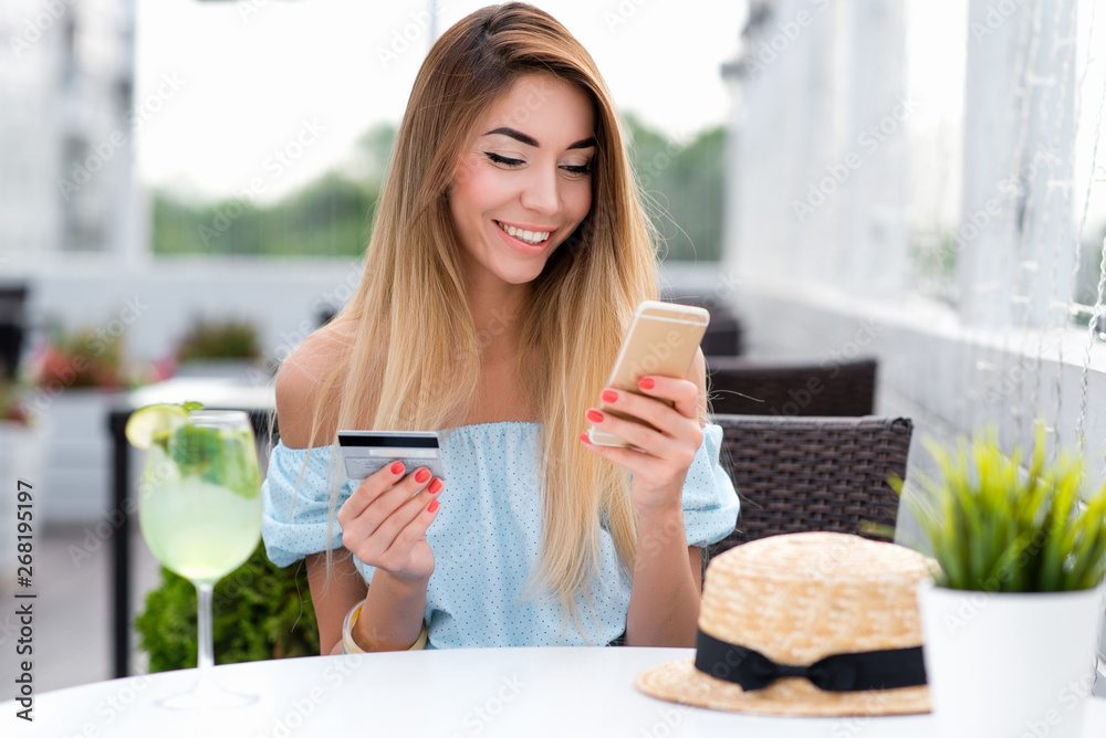 Woman summer cafe, hand credit card phone, pays purchase, orders goods, writes off money account. Contactless payment, breakfast, lunch. Online app enters password. Happy smiles, emotions joy fun. Woman summer cafe, hand credit card phone, pays purchase, orders goods, writes off money account. Contactless payment, breakfast, lunch. Online app enters password. Happy smiles, emotions joy fun.
