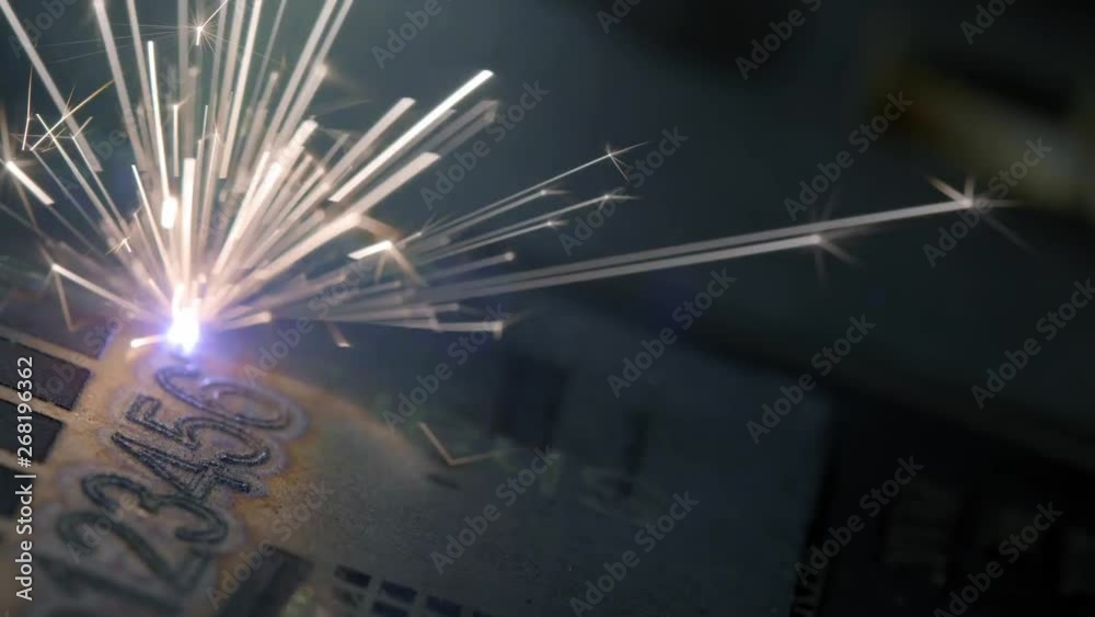 Laser Marking Machine Engraving. laser engraving on metal. Make a set of numbers. New technologies in metal processing. Glowing laser beam burns on the metal.