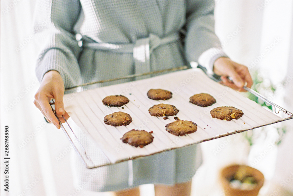 woman holding a baking pan with cookies woman holding a baking pan with cookies