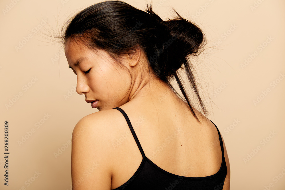 © leandro crespi/Stocksy - Young beautiful Asian woman portrait thinking isolated over colorful background © leandro crespi/Stocksy - Young beautiful Asian woman portrait thinking isolated over colorful background