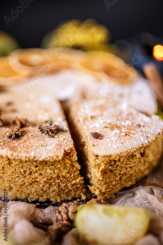 Biscuit apple pie with cinnamon  citron  oriental spices and sugar powder on dark background