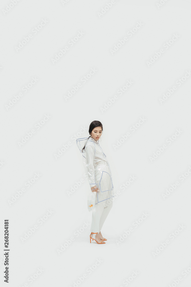 Female in white fashionable outfilt with goldfish. Female in white fashionable outfilt with goldfish.