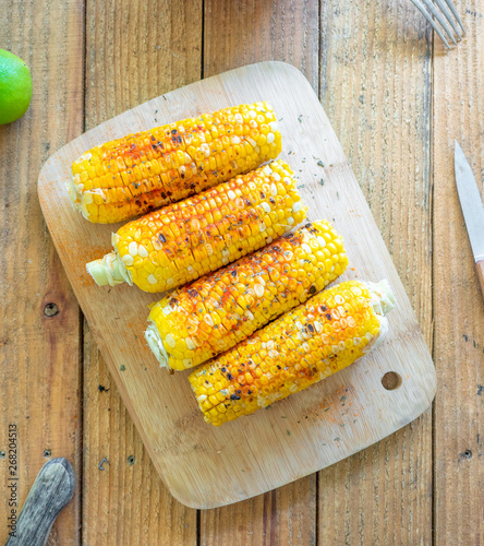 Grilled corn on the cob with spices, cheese, and herbs. Also known as Mexican Elote