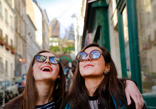 Happy beautiful student girls in Paris on the street