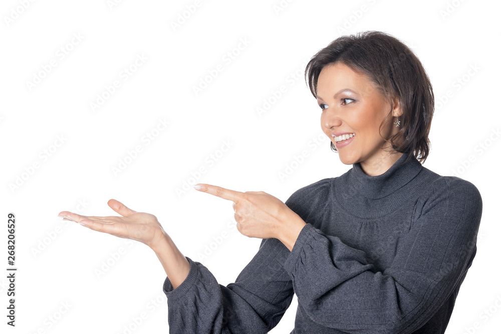 Young beautiful woman pointing on something on white background Young beautiful woman pointing on something on white background