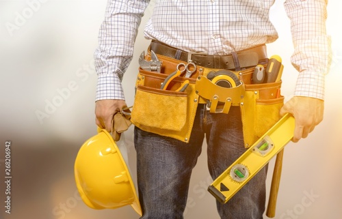 Male worker with tool belt isolated on white  background © BillionPhotos.com