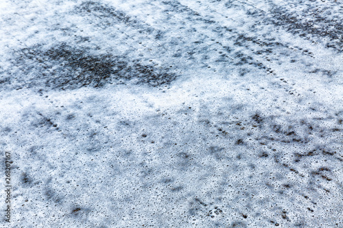 Texture of sea foam on sand, closeup. Background. Space for text.