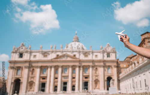 Closeup toy airplane on St. Peter's Basilica church in Vatican city background. photo