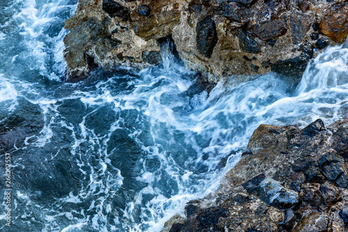 Raging sea on the rocky shore, close-up. Space for text.