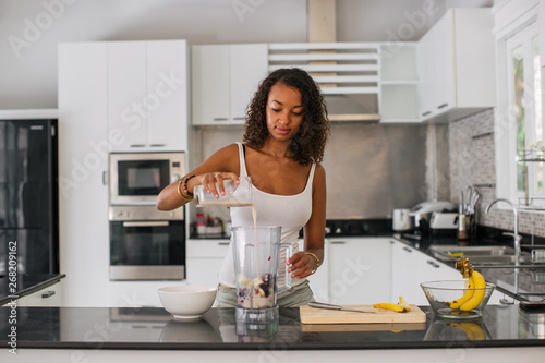 Young girl making a smoothie