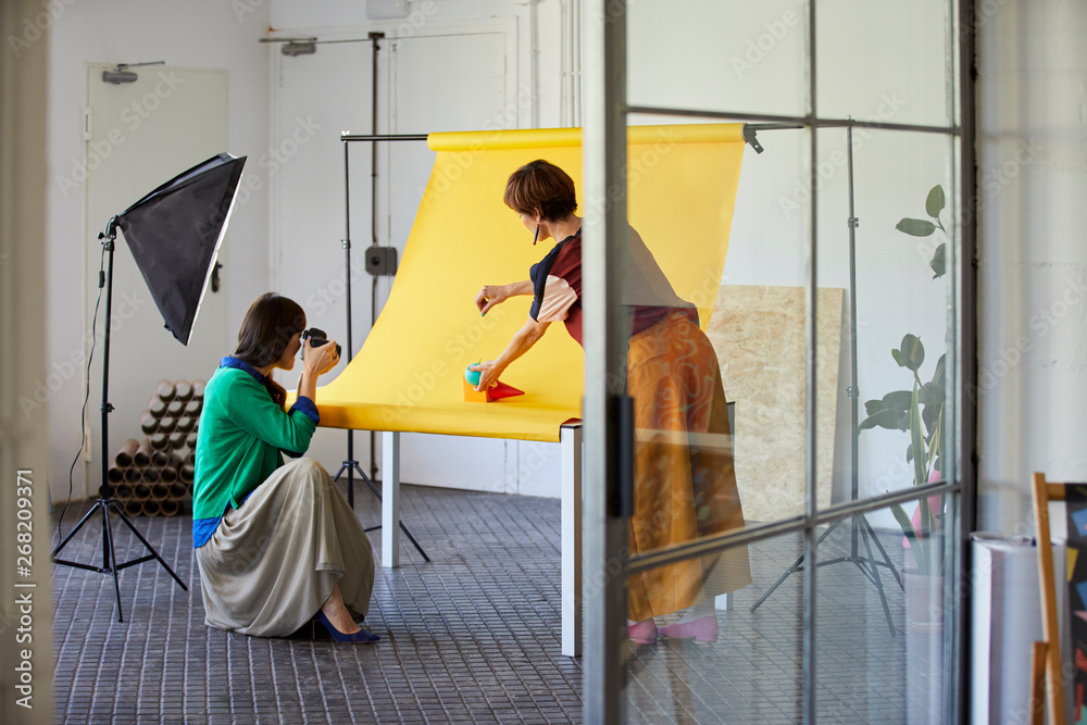 Professional With Colleague Photographing Objects Stock Photo | Adobe Stock